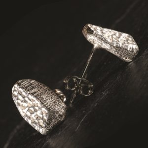 Chunky silver stud inspired by prehistoric carvings from Bachwen, North Wales. Handmade by Silverfish Designs