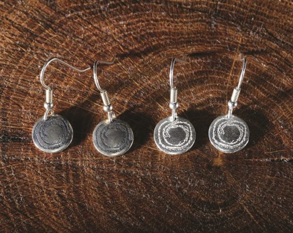 Simple disc drops ispired by prehistoric carvings from North Wales. Created by Carol James of Silverfish Designs