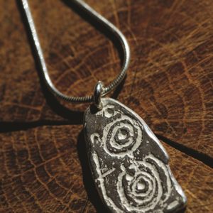 a large silver pendant inspired by The Llwydiarth Esgob stone from Anglesey. Created by Carol James of Silverfish Designs
