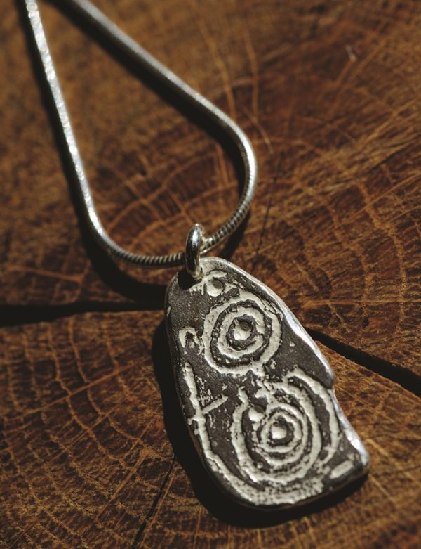 a large silver pendant inspired by The Llwydiarth Esgob stone from Anglesey. Created by Carol James of Silverfish Designs