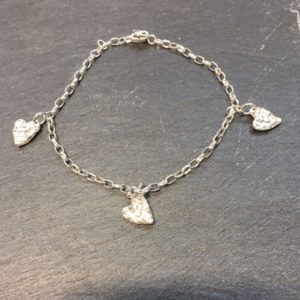 Sterling silver link bracelet with 3 tiny solid silver hearts, reticulated to give a lovely textural finish. Silver jewellery designed and handmade by Carol James of Silverfish Designs.