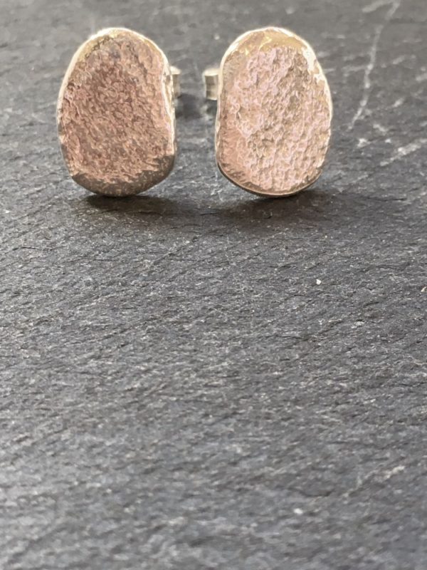 sterling silver small pebble studs cast from beach pebbles from Anglesey. Designed and handmade by Carol James of Silverfish Designs