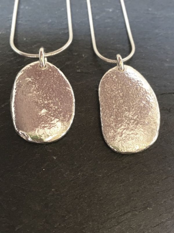 Large silver pendant cast from a natural beach pebble from Anglesey. Designed and handmade by Carol James of Silverfish Designs